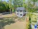 Aerial view of a two story home with a spacious backyard, lush green grass, and mature trees at 6273 Ballpark Rd Rd, Hollywood, SC 29449
