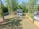 Aerial view of a two story home with a spacious backyard, lush green grass, mature trees, and a wood fence at 6273 Ballpark Rd Rd, Hollywood, SC 29449