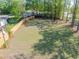Large backyard with mature trees surrounded by a wood fence with an adjacent home at 6273 Ballpark Rd Rd, Hollywood, SC 29449