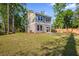Expansive backyard featuring lush green grass, mature trees, a wood fence, and a two story home at 6273 Ballpark Rd Rd, Hollywood, SC 29449