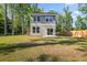 Two story home with a spacious backyard, lush green grass, mature trees, and a wood fence at 6273 Ballpark Rd Rd, Hollywood, SC 29449