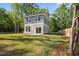 Spacious backyard featuring lush green grass, mature trees, a wood fence, and a two story home at 6273 Ballpark Rd Rd, Hollywood, SC 29449