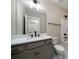 Bathroom with a vanity and a framed mirror adjacent to a toilet and walk-in shower at 6273 Ballpark Rd Rd, Hollywood, SC 29449
