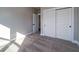 Carpeted bedroom featuring a neutral color scheme, closet, and adjoining door at 6273 Ballpark Rd Rd, Hollywood, SC 29449