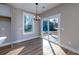 Dining area features sliding glass doors to the backyard, a modern chandelier, and wood-look flooring at 6273 Ballpark Rd Rd, Hollywood, SC 29449