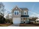Charming two-story home features a covered front entry, attached garage, and neutral two-tone siding at 6273 Ballpark Rd Rd, Hollywood, SC 29449