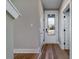 Bright foyer boasts wood-look flooring, modern doors and hardware, and an entry door with glass insert at 6273 Ballpark Rd Rd, Hollywood, SC 29449