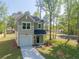 Charming two-story home with a well-manicured lawn, driveway, attached garage, and mature trees at 6273 Ballpark Rd Rd, Hollywood, SC 29449
