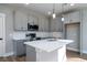 Modern kitchen showcasing grey cabinets, white countertops, stainless steel appliances, and wood-look flooring at 6273 Ballpark Rd Rd, Hollywood, SC 29449