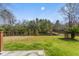 Large, grassy backyard area is enclosed by a wooden fence, perfect for outdoor activities at 644 Stoneboro Ct, Charleston, SC 29412