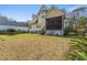Spacious backyard with a screened porch on a yellow two story house with a wooden fence at 644 Stoneboro Ct, Charleston, SC 29412