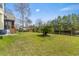 Expansive backyard featuring a lush lawn, mature trees, and a charming fence enclosing the property at 644 Stoneboro Ct, Charleston, SC 29412
