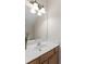 A cozy, well-lit bathroom featuring white walls, wood cabinets, and a large mirror over the sink at 644 Stoneboro Ct, Charleston, SC 29412