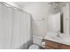 A bright bathroom with tile floors, a toilet, a sink with wood-colored cabinets, and a shower with shower curtain at 644 Stoneboro Ct, Charleston, SC 29412