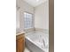 Bright bathroom featuring a large soaking tub and neutral tile accents at 644 Stoneboro Ct, Charleston, SC 29412