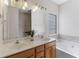 Bathroom features double sinks, garden tub, and natural lighting at 644 Stoneboro Ct, Charleston, SC 29412