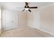 This bedroom boasts a ceiling fan, neutral carpeting, a window, and ample storage with double closets at 644 Stoneboro Ct, Charleston, SC 29412