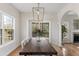 Dining area with natural light, modern chandelier, access to screened porch and view of fireplace at 644 Stoneboro Ct, Charleston, SC 29412