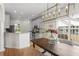 Bright dining area features modern chandelier, natural light, and adjacent kitchen at 644 Stoneboro Ct, Charleston, SC 29412