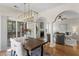 Open floor plan dining area with modern chandelier view of screened porch, living room, and fireplace at 644 Stoneboro Ct, Charleston, SC 29412