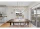 Dining area features modern chandelier, natural light, and sliding glass door at 644 Stoneboro Ct, Charleston, SC 29412