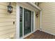 Charming front door with decorative details, sidelights, and outdoor lighting at 644 Stoneboro Ct, Charleston, SC 29412