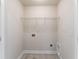 Functional laundry room with tile floor and built-in wire shelving at 644 Stoneboro Ct, Charleston, SC 29412