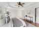Inviting bedroom features ceiling fan, tray ceilings, and warm decor at 644 Stoneboro Ct, Charleston, SC 29412