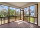Enjoy the outdoors from the screened porch with wood decking, railing, and a view of the tranquil water at 644 Stoneboro Ct, Charleston, SC 29412
