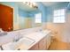 Bright bathroom with double sinks, a large mirror, and a tiled shower/tub combo at 7 Doughty St # C, Charleston, SC 29403