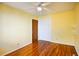 Sunny bedroom with hardwood floors, closet, and modern ceiling fan at 7 Doughty St # C, Charleston, SC 29403