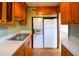 Efficient kitchen featuring combined washer/dryer unit, refrigerator, and ample cabinet space at 7 Doughty St # C, Charleston, SC 29403