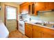 Functional kitchen features bright countertops, a stainless steel sink, and wood cabinets at 7 Doughty St # C, Charleston, SC 29403