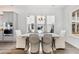 Dining area with hardwood floors, a light chandelier, and large windows that flood the room with natural light at 796 Clay Field Trl, Summerville, SC 29485