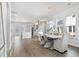 Bright, open-concept dining area featuring hardwood floors, large windows, and a view of the kitchen at 796 Clay Field Trl, Summerville, SC 29485