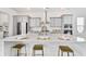 Stylish kitchen island with white countertops, bar stools, and stainless steel appliances, perfect for entertaining at 796 Clay Field Trl, Summerville, SC 29485