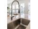 Close-up of a modern kitchen sink with a stylish faucet, set against a backdrop of bright windows at 796 Clay Field Trl, Summerville, SC 29485
