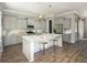Modern kitchen featuring gray cabinets, stainless steel appliances, and a marble countertop island with stylish seating at 798 Clay Field Trl, Summerville, SC 29485