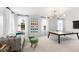A bright bonus room features a ping pong table, comfortable seating and unique wall art at 800 Clay Field Trl, Summerville, SC 29485