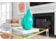 Close-up of a stylishly decorated living room with a modern fireplace and vibrant accents at 800 Clay Field Trl, Summerville, SC 29485