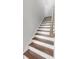 A staircase with dark wood treads and white risers ascends to the next level at 800 Clay Field Trl, Summerville, SC 29485