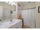 Clean bathroom featuring a vanity with white marble countertop, a shower, and tasteful decorations at 8661 Refuge Point Cir, North Charleston, SC 29420