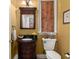 Charming powder room featuring a decorative mirror, vanity with dark finish, and stylish fixtures at 8661 Refuge Point Cir, North Charleston, SC 29420