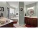 Bright bathroom featuring dual vanities, soaking tub and separate shower at 8661 Refuge Point Cir, North Charleston, SC 29420
