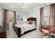 Cozy bedroom with floral bedding, two windows, and dark wood furniture creating a comfortable retreat at 8661 Refuge Point Cir, North Charleston, SC 29420