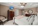 This bedroom includes a ceiling fan and private ensuite bathroom at 8661 Refuge Point Cir, North Charleston, SC 29420