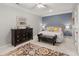 Serene bedroom featuring a blue accent wall, plush bedding, and elegant furnishings, designed for rest at 8661 Refuge Point Cir, North Charleston, SC 29420