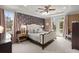 This main bedroom includes a ceiling fan, tray ceiling, and access to a balcony at 8661 Refuge Point Cir, North Charleston, SC 29420