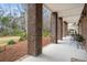 Inviting covered patio with brick pillars, providing ample space for outdoor seating and entertaining at 8661 Refuge Point Cir, North Charleston, SC 29420