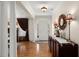 Elegant foyer with hardwood floors, wainscoting, decorative mirror, and ample natural light creating an inviting entrance at 8661 Refuge Point Cir, North Charleston, SC 29420